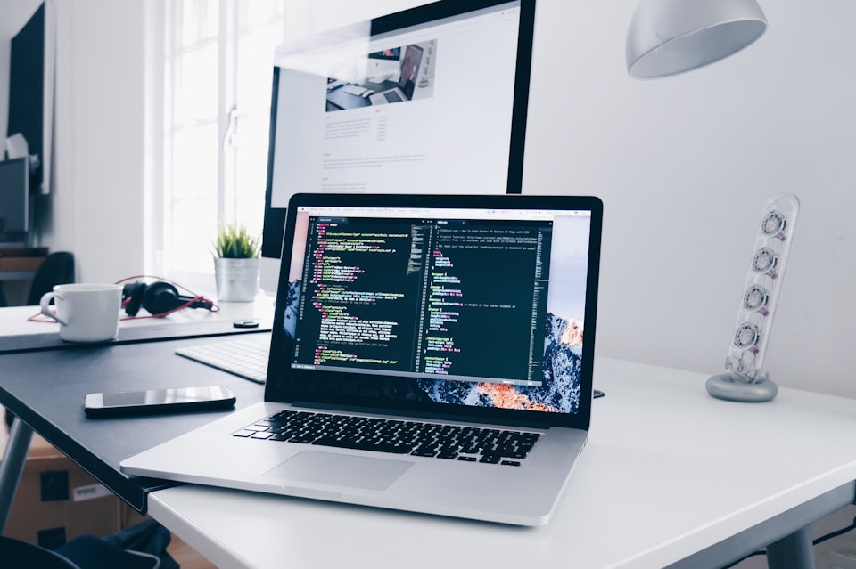 Developer building modern MERN stack applications on a multi-screen setup